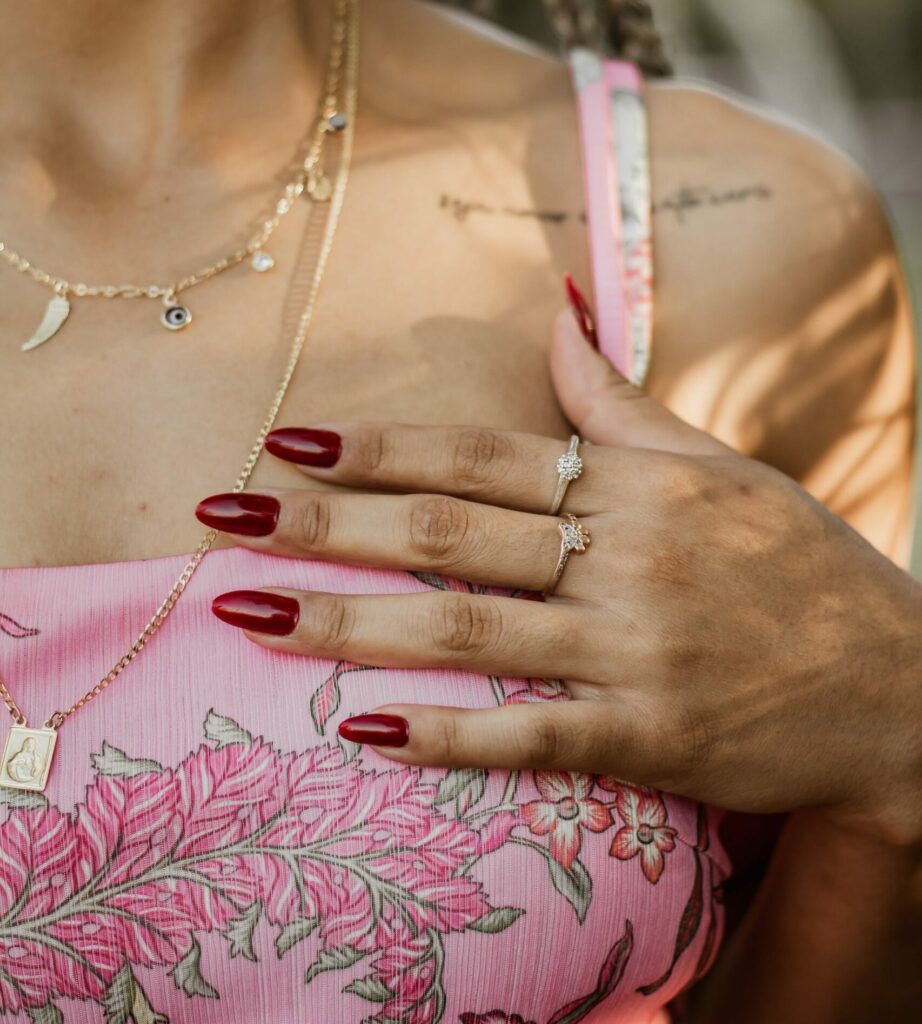 A Woman Placing Her Hand On Her Chest With Red Nails. Valentines Day Nail ideas