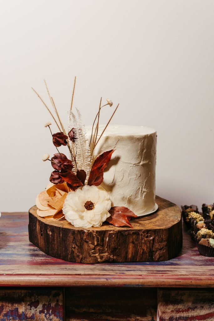 Rustic Wedding Cake. White Cake on a Slice of Wood